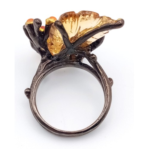 227 - A late Victorian or Edwardian, unique, sterling silver ring with large carved gemstones creating a n... 