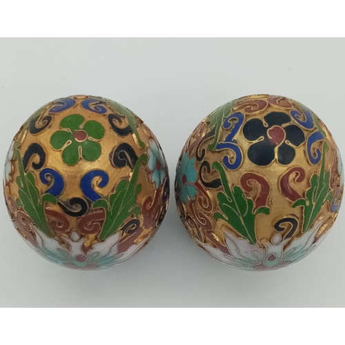 279 - Two very ornamental Chinese cloisonné eggs on wooden base. Height: 7 cm