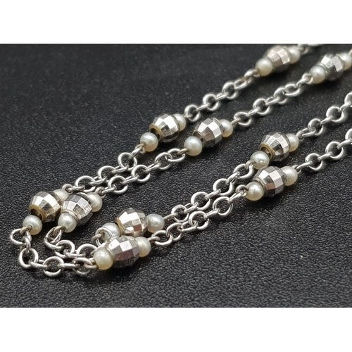 748 - An 18K White Gold and Seed Pearl Necklace with faceted barrel-shaped spacers. 3.6g total weight. 50c... 