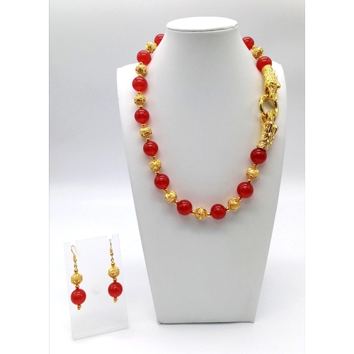 138 - A glamorous, Chinese, red jade, necklace and earrings set with 18 K yellow gold plated dragon clasp.... 