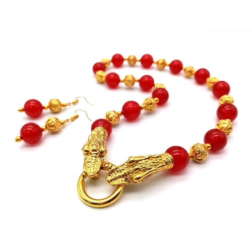 138 - A glamorous, Chinese, red jade, necklace and earrings set with 18 K yellow gold plated dragon clasp.... 