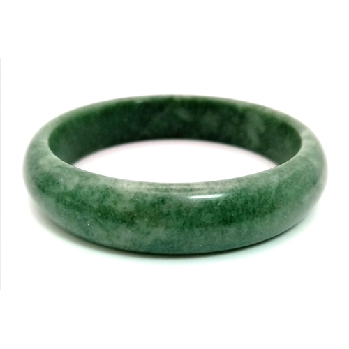 489 - A Green Jade Bangle. 6cm inner diameter.