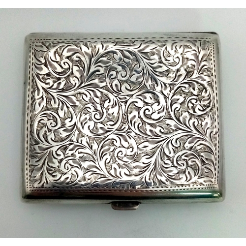 589 - An Antique Silver Cigarette Case. Engraved scroll decoration with initialled cartouche. Gilded inter... 