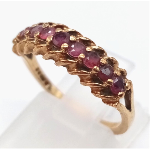 84 - An Antique 9K Yellow Gold Ruby Half-Eternity Ring. Size M. Nine quality round cut rubies. 2.23g tota... 