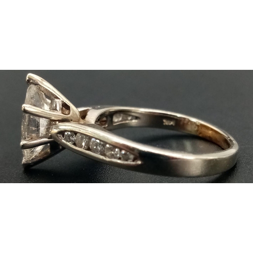 56 - A 14K White Gold Marquise-Cut Diamond Ring. 1.5ct central stone with a further ten graduated round c... 