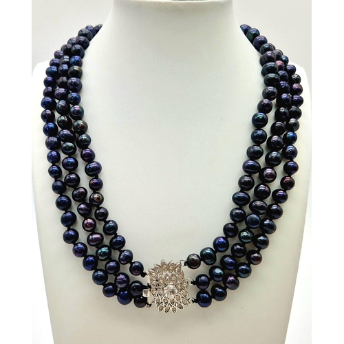 103 - A vintage, necklace with 3 rows of natural, individually hand knotted, Tahitian, black pearls and a ... 