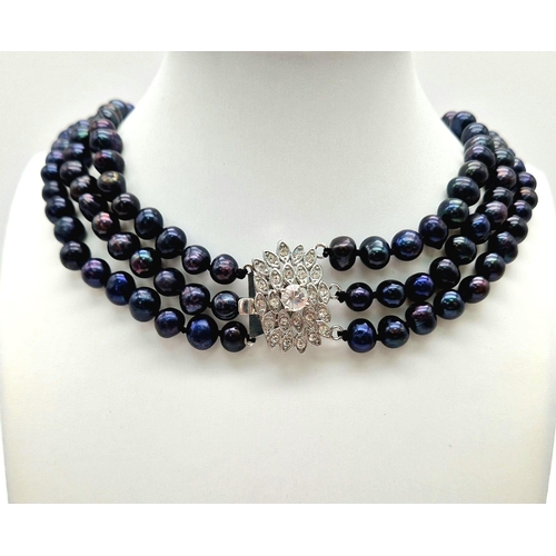 103 - A vintage, necklace with 3 rows of natural, individually hand knotted, Tahitian, black pearls and a ... 