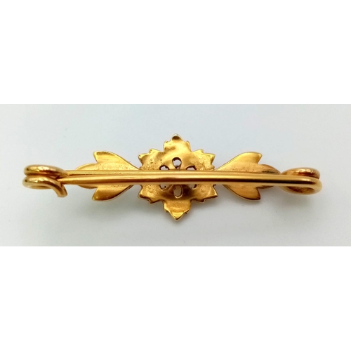 123 - A Victorian High Karat and Seed Pearl bar Brooch. Floral decoration. Comes with original Gibson and ... 