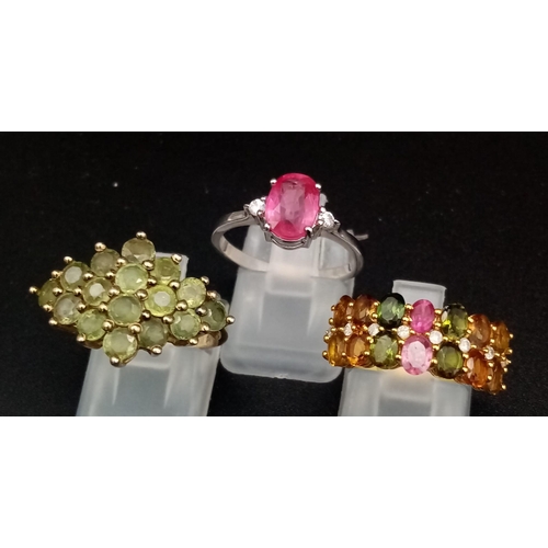 487 - Three 925 Silver Gemstone Rings (two gilded). Peridot, pink topaz and multi-gem. 2 x M, 1 x N.