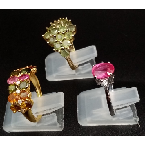 487 - Three 925 Silver Gemstone Rings (two gilded). Peridot, pink topaz and multi-gem. 2 x M, 1 x N.