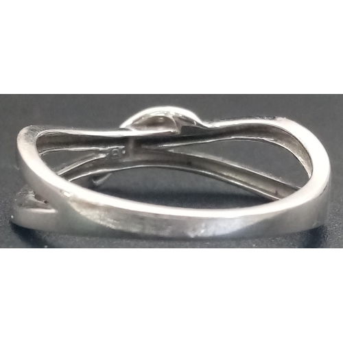 575 - A 9K White Gold Diamond Crossover Ring. Size M/N. 2.03g total weight.