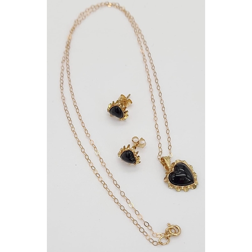 585 - A 9K Yellow Gold Pendant and Onyx Heart  Earring Set. Pendant is on a 9K gold disappearing necklace.... 