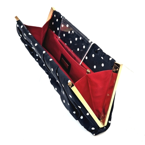 346 - A Dolce and Gabana Polka Dot Silk Clutch Bag. Red interior with zipped compartment. Gilded hardware.... 