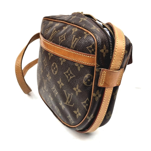 314 - A Louis Vuitton Jeune Fille Crossbody Bag. Monogram canvas and brown leather. Large buckle-open fron... 