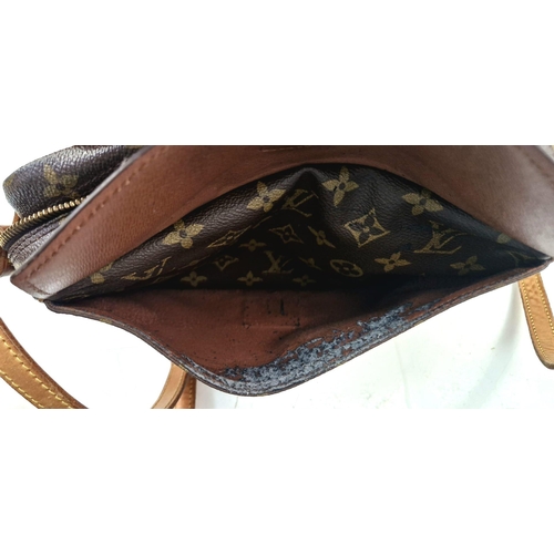 314 - A Louis Vuitton Jeune Fille Crossbody Bag. Monogram canvas and brown leather. Large buckle-open fron... 