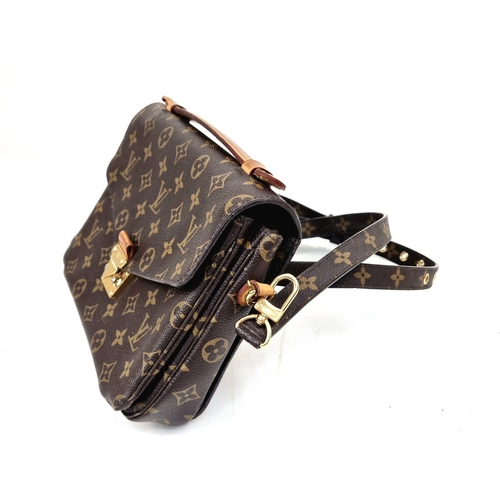 45 - A Louis Vuitton Pochette Metis Bag. Monogram canvas. Gilded hardware. Outer zipped compartment. Deta... 