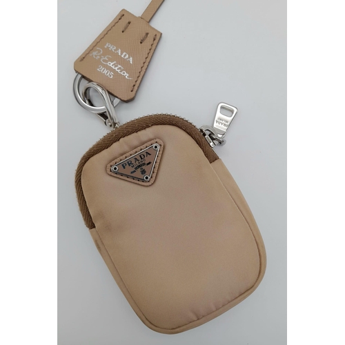 536 - A Prada Mini-Hobo Bag in Desert Beige Nylon. Comes with a detachable pouch on an adjustable strap. M... 