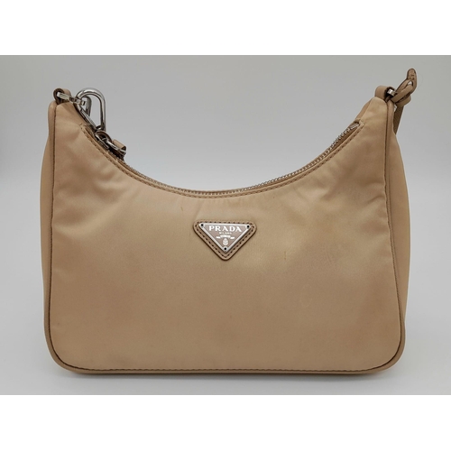 536 - A Prada Mini-Hobo Bag in Desert Beige Nylon. Comes with a detachable pouch on an adjustable strap. M... 