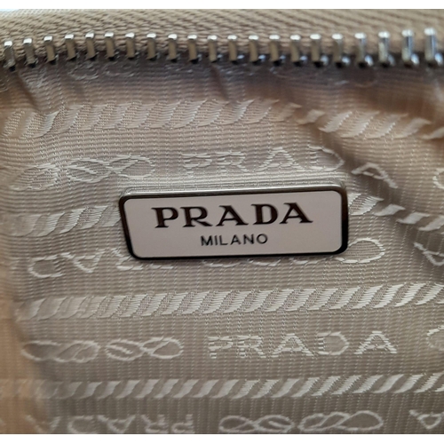 536 - A Prada Mini-Hobo Bag in Desert Beige Nylon. Comes with a detachable pouch on an adjustable strap. M... 