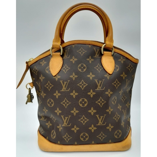 161 - A Louis Vuitton Lockit Handbag. Monogram canvas and brown leather exterior. Lock with key. 25 x 28cm... 