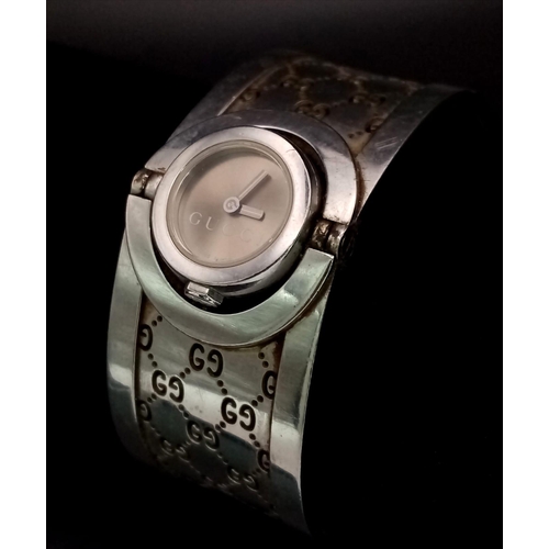 428 - A Stylish Gucci Ladies Flip-Watch. Stainless steel strap and case - 15mm. Needs a battery.  Ref:1130... 