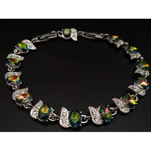 492 - A Mystic Topaz Tennis Bracelet. On white metal with white stone decoration. 20cm.