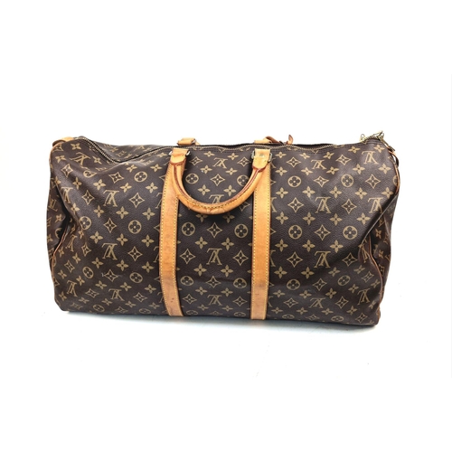 113 - A Louis Vuitton Keepall - Bandouliere 55. Monogram LV brown canvas and leather. 55 x 31 x 26cm. In g... 