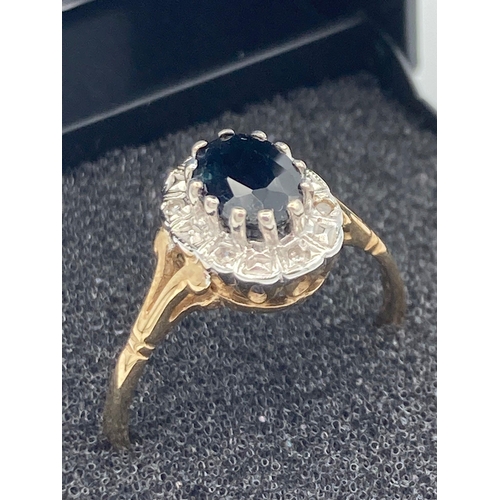 48 - 9 carat GOLD,SAPPHIRE and DIAMOND RING.Having oval Sapphire set to top with Diamond surround. Full U... 