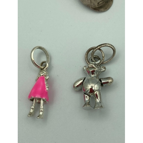 742 - Selection of Hallmarked SILVER CHARMS to include Dolphin, teddy bear, Dolly,etc. Full UK hallmarks. ... 