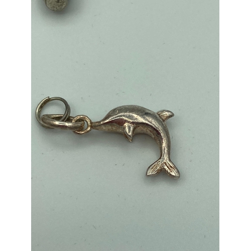 742 - Selection of Hallmarked SILVER CHARMS to include Dolphin, teddy bear, Dolly,etc. Full UK hallmarks. ... 