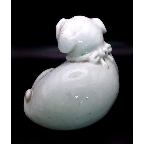 283 - AN ANTIQUE JAPANESE HIRADO PORCELAIN OKIMONO FIGURE OF A PUPPY FROM THE EDO PERIOD . 17cms LONG AND ... 