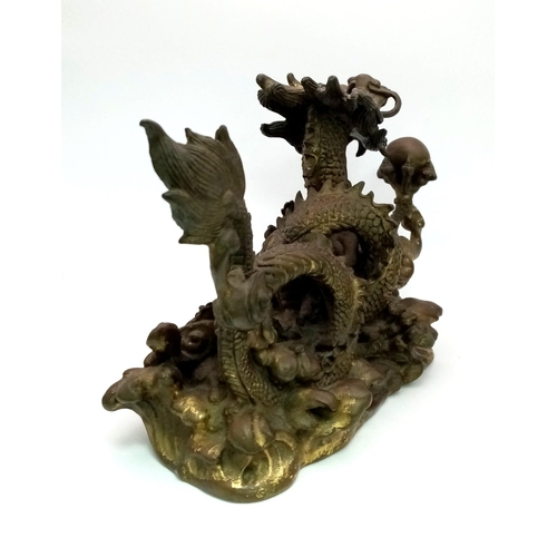 9 - A Chinese Qing Dynasty Dragon with Pearl Ball Bronze. Inspired by the legend of the dragon and the p... 