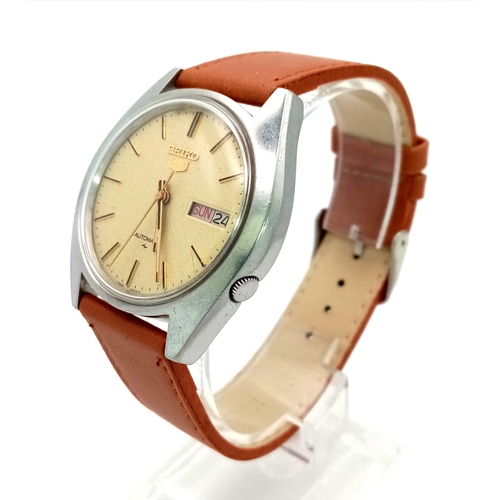 989 - A Vintage Seiko 5 Automatic Gents Watch. Brown leather strap. Beige dial with day/date window. In wo... 