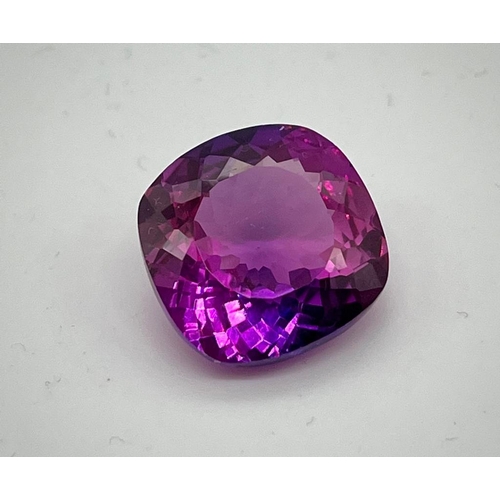 673 - A 24ct Purple/Pink Tanzanite. Cushion cut with 17 x 17 x 8mm dimensions. No visible inclusions. Heat... 