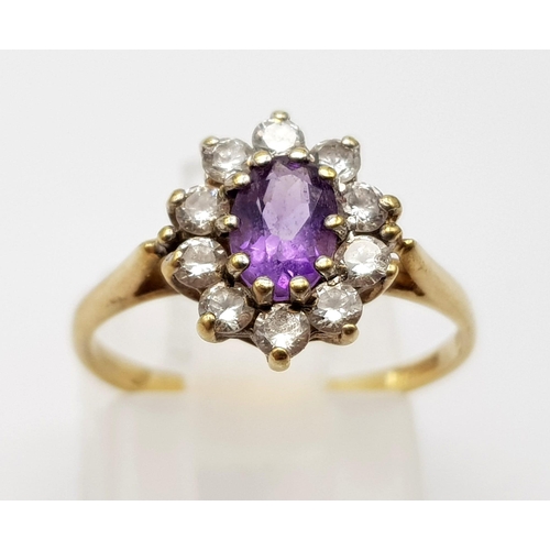 995 - A 9K Yellow Gold Amethyst Ring with White Stone Surround. 
Size K. 1.62g total weight.