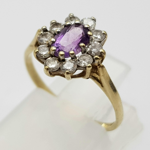 995 - A 9K Yellow Gold Amethyst Ring with White Stone Surround. 
Size K. 1.62g total weight.