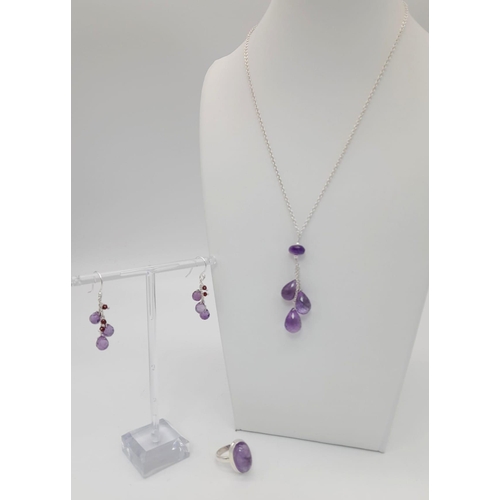 1214 - 925 Silver Amethyst Drops Necklace, Earrings and Ring Set.
Total Weight 17.56grams. Necklace 8.26g. ... 