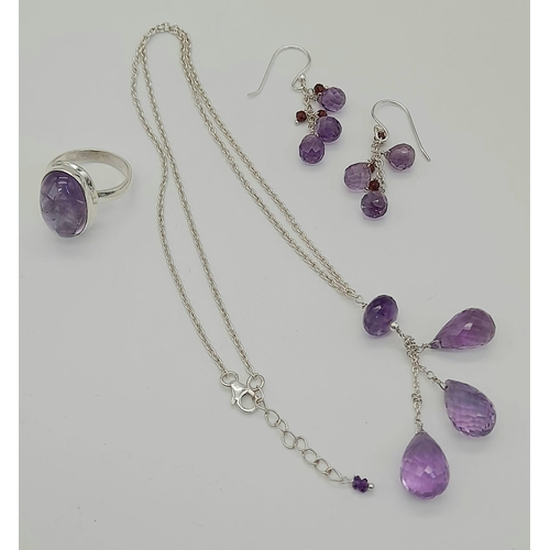 1214 - 925 Silver Amethyst Drops Necklace, Earrings and Ring Set.
Total Weight 17.56grams. Necklace 8.26g. ... 