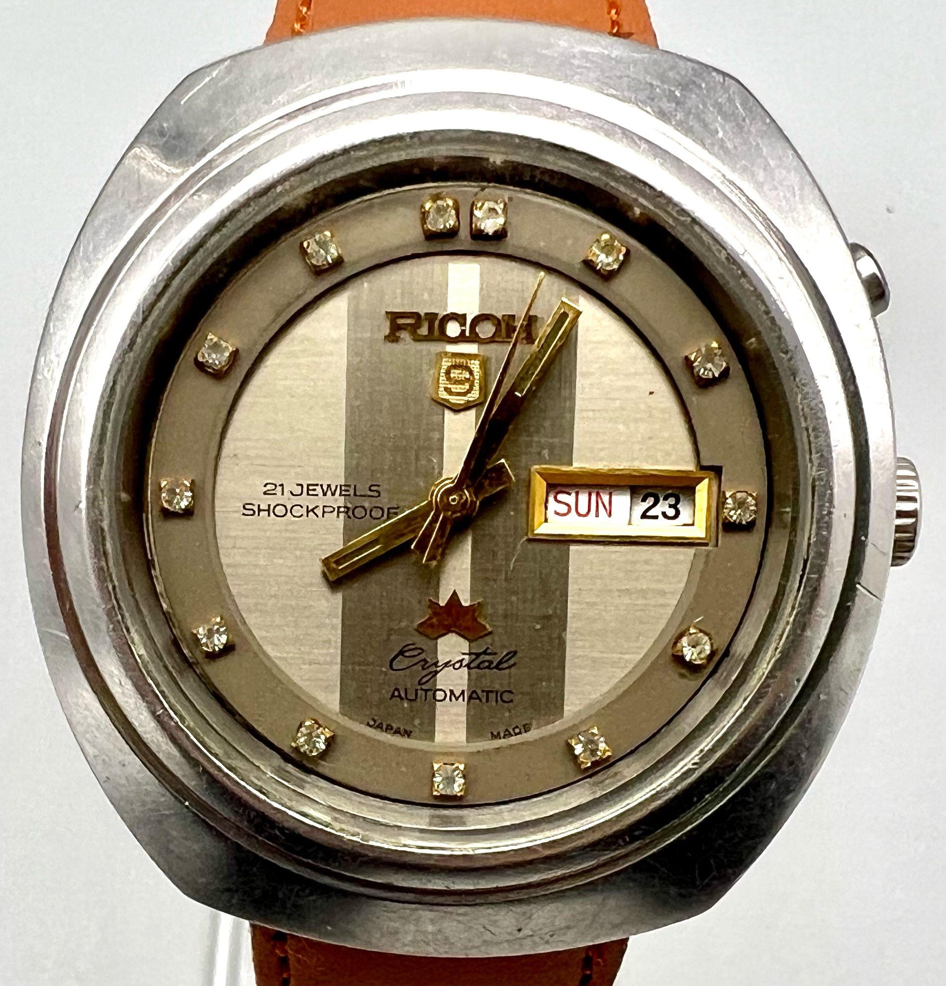 A Rare Vintage Ricoh Crystal 21 Jewel Automatic Gents Watch. Brown leather strap. Stainless steel ca