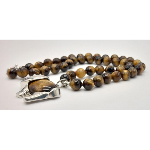 743 - A Tigers Eye Necklace with an Elephant Pendant. Pendant - 4cm. Necklace - 42cm. Beads - 8mm.