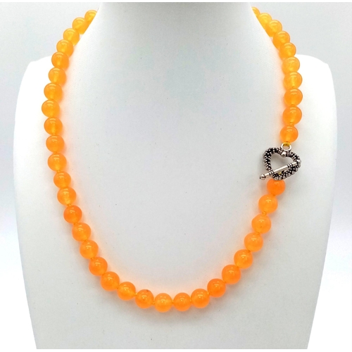 758 - An Orange Topaz Small Bead Necklace. Heart clasp. 8mm beads. 42cm