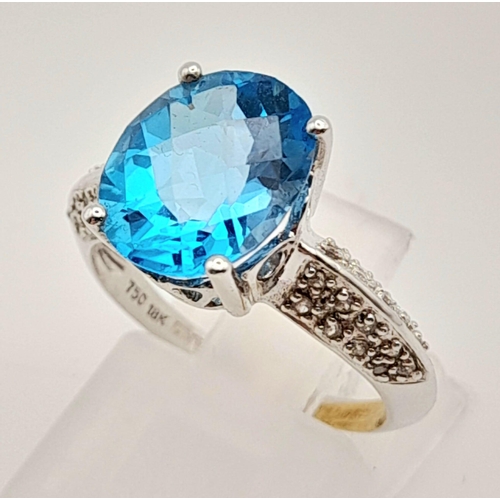 163 - A Mesmerising 18K White Gold Topaz and Diamond Ring. Central Ice-Blue Oval Cut Topaz with diamonds o... 