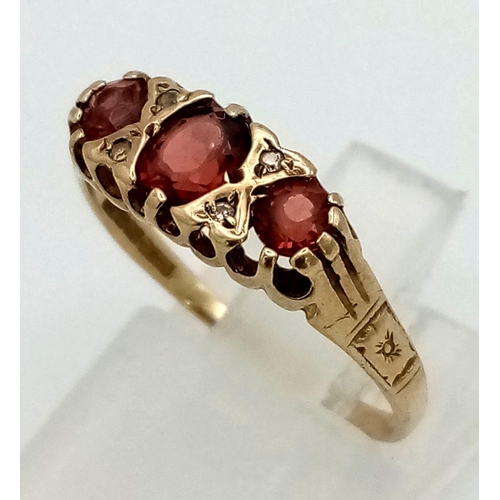 184 - An Antique 9K Yellow Gold Garnet and Diamond Ring. Three rich garnets and four small diamonds. Size ... 