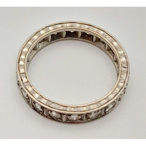 92 - A Platinum Diamond Eternity Ring. 20 round cut diamonds.
Size J. 3.74g total weight.