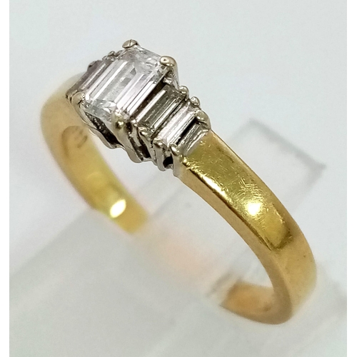 170 - An 18K Yellow Gold Graduating Emerald-Cut Diamond Ring. 
Size K/L. 4.07g total weight. 0.48ct.