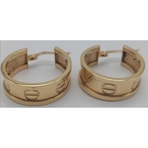 414 - A 14K Yellow Gold Pair Of Hoop Earrings. Screw decoration. 
4.2g total weight. Ref: 6-2488.