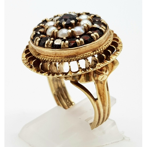 779 - A VINTAGE 9K GOLD REGAL RING WITH GARNETS AND SEED PEARLS.10.6gms   size O/P