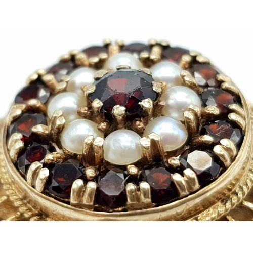 779 - A VINTAGE 9K GOLD REGAL RING WITH GARNETS AND SEED PEARLS.10.6gms   size O/P