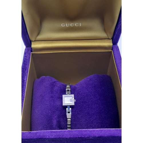 875 - A LADIES DIAMOND GUCCI LADIES WRIST WATCH WIRH SQUARE FACE IN STAINLESS STEEL. GOOD CONDITION  F.W.O... 