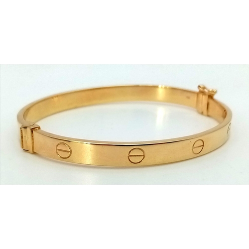 874 - A 9K Yellow Gold Cartier-Style Bangle. 6cm inner diameter. 8.5g.